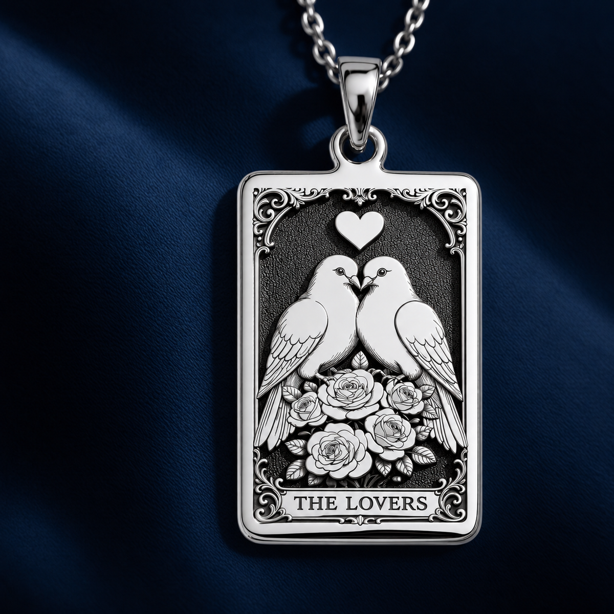 Silver pendant necklace featuring a charm design of two birds facing each other, with a polished surface finish. The view is a close-up of the pendant itself.