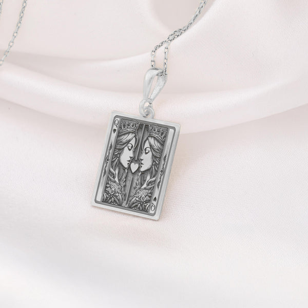 Silver Ace of Queens pendant with two intricately detailed queens and a heart symbol, symbolizing love, pride, and connection. Ideal LGBTQ+ jewelry piece.