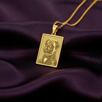Close-up of a custom engraved 14K gold plated necklace showing an anthropomorphic Pug portrait, a perfect quirky gift for a Pug dad.
