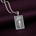 Front-facing view of the 925 Sterling Silver Doberman necklace, showcasing its cool, bright metallic tone that contrasts sharply with the dark satin fabric.