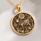 Kamadhenu Cow Hindu Cow Pendant Necklaces 14K 14K Gold Plated pendant necklace featuring an ornate bull design with floral wreath and figures.