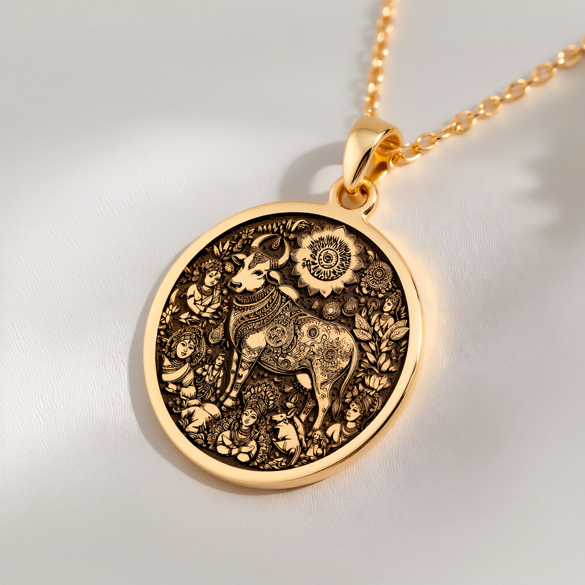 Kamadhenu Cow Hindu Cow Pendant Necklaces 14K 14K Gold Plated pendant necklace featuring an intricate elephant design in a circular frame.