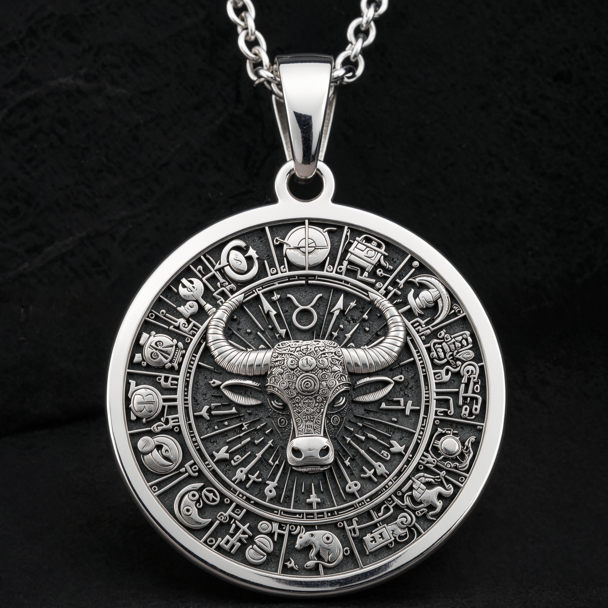 Silver Taurus Bull Zodiac necklace with a detailed bull pendant design. The image shows a flat lay view of the necklace, highlighting the silver material and the engraved details. It is a statement piece suitable for astrological jewelry.