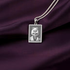 Front-facing view of the 925 Sterling Silver Persian Cat necklace, showcasing its bright, cool finish against the deep purple satin background.