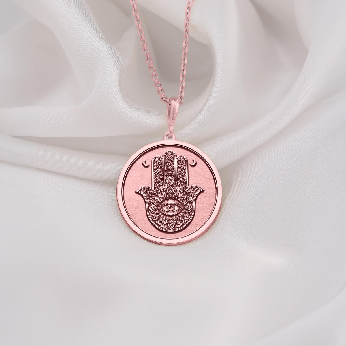 Rose Gold Plated Hamsa pendant with Evil Eye charm, a symbol of divine protection and harmony. Feminine and meaningful gift choice for birthdays, holidays, or spiritual milestones.