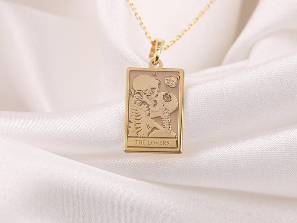 &quot;Gold &#39;The Lovers&#39; Skeleton Charm Necklace featuring two intertwined skeletons symbolizing eternal love. A unique gothic pendant, perfect for Halloween or romantic gifts. Gold-plated, adjustable chain. Ideal for dark, alternative fashion lovers.&quot;