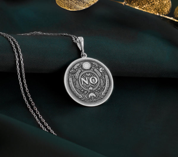 925 Sterling Silver NO Pendant with detailed boundary design. Handcrafted silver coin charm featuring empowering affirmation surrounded by protective evil eye, moon and laurel elements. Self-respect jewelry celebrating personal sovereignty.