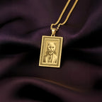A slightly angled view of the 14K Solid Gold Scottish Fold pendant, highlighting the polished frame and the cat's formal, engraved attire.