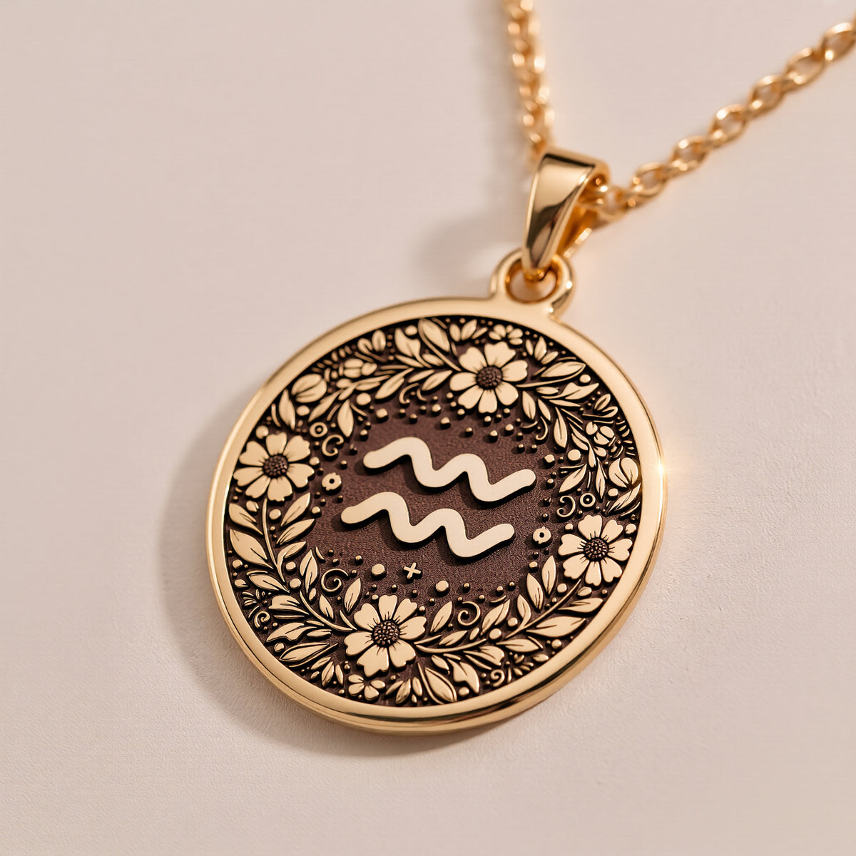 14K Solid Gold Aquarius Zodiac Medallion featuring water bearer symbol surrounded by intricate floral botanical patterns and decorative elements. Detailed astrology coin pendant with celestial symbolism. Luxury Aquarius jewelry representing cosmic wi