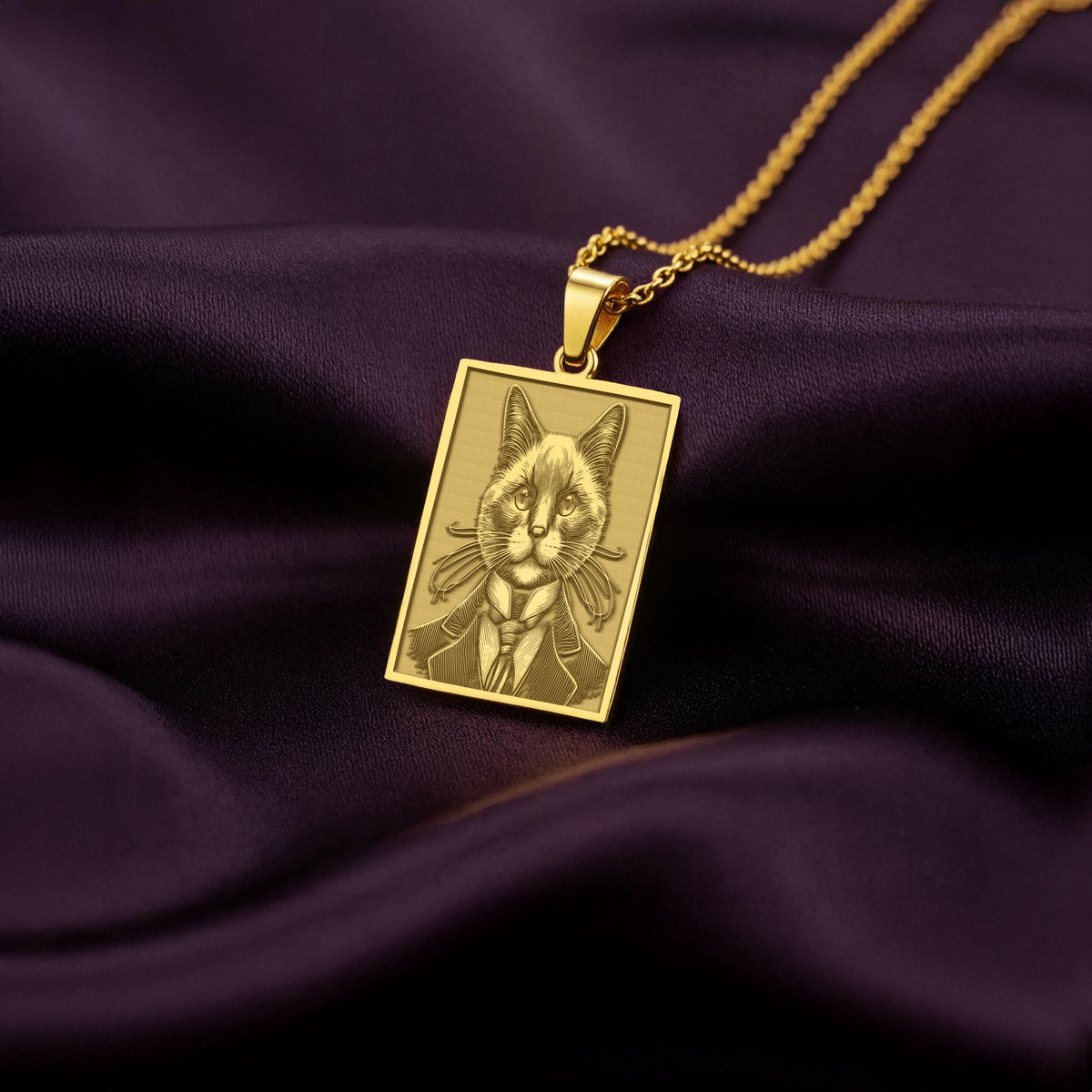 Close-up of a custom engraved 14K gold plated necklace showing an anthropomorphic Siamese cat portrait, a perfect gift for a cat dad.