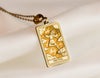 gold The Fool tarot card charm necklace, a vintage pendant necklace ideal for layering. This unique pendant makes a perfect good luck charm, protection necklace, or birthday pendant, adding mystique to a personalized charm necklace collection