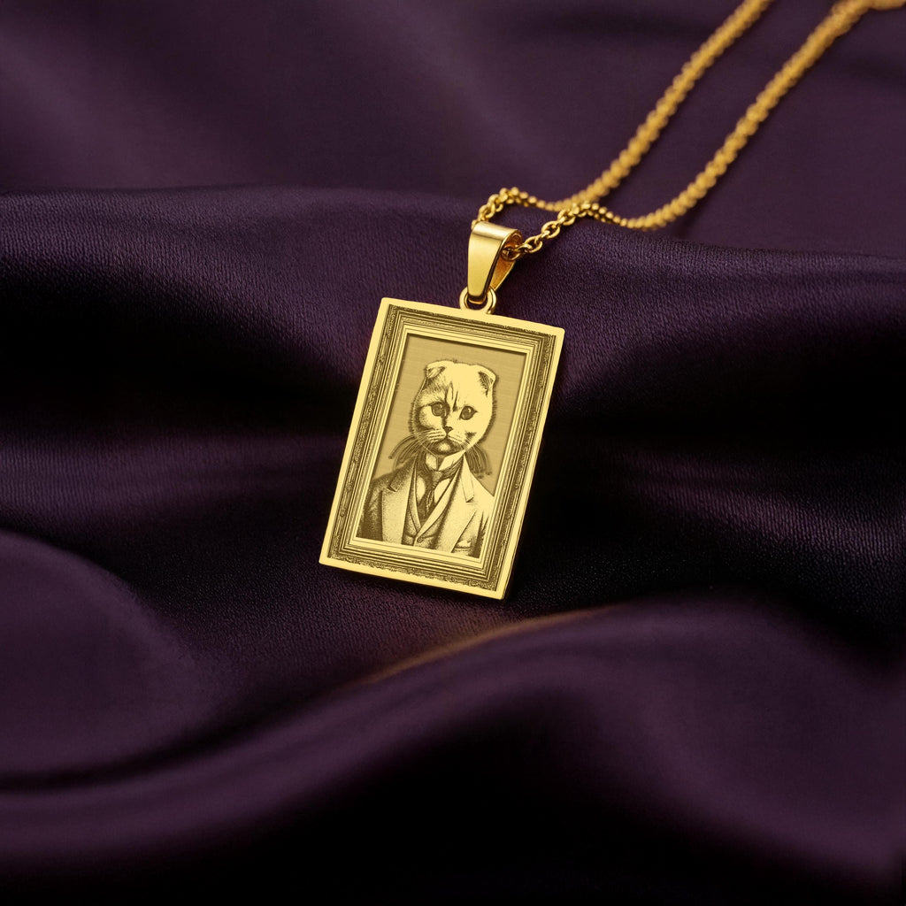 Product photo of a 14K Solid Gold Scottish Fold necklace from the 'Victorian Pet Collection'. The engraved cat is portrayed as a dapper gentleman in a suit and tie.