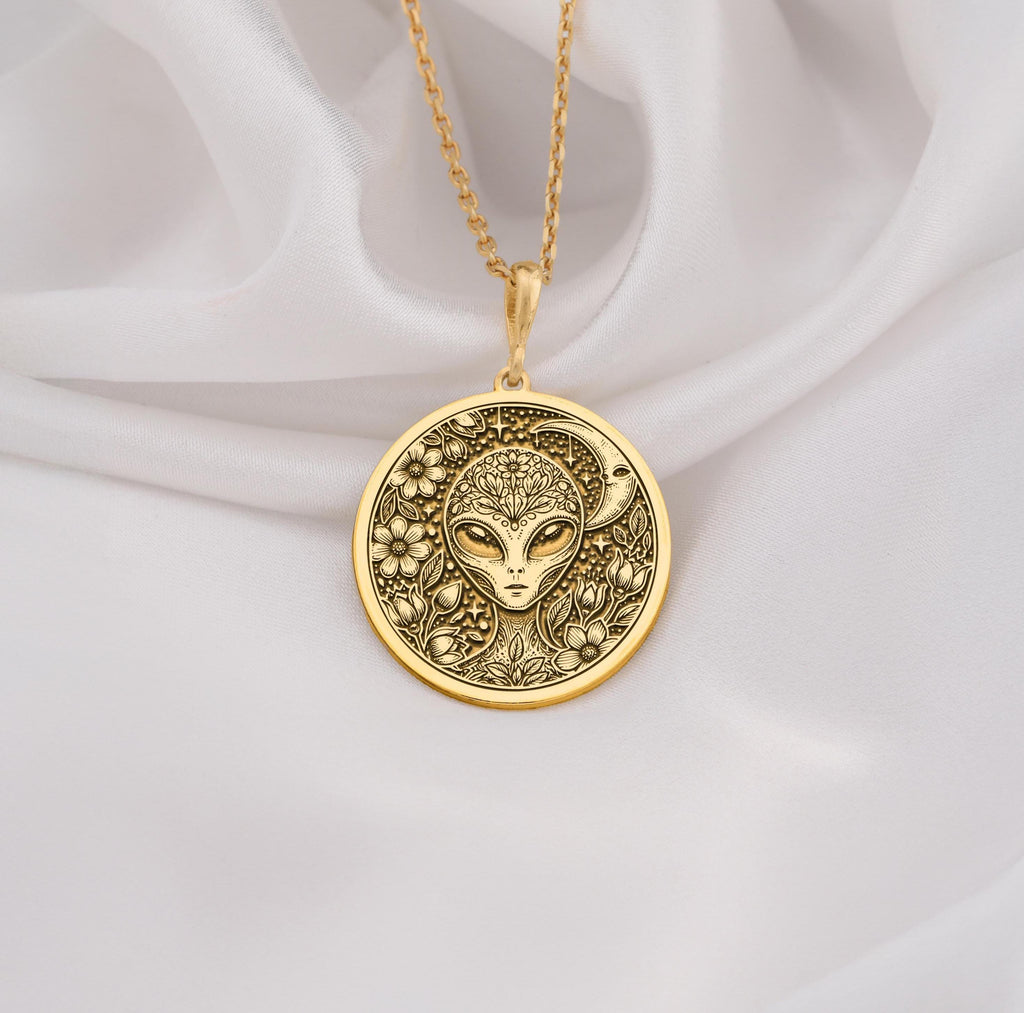 Mystical 14K gold alien pendant, featuring a detailed extraterrestrial medallion with floral cosmic engravings. A stunning sci-fi jewelry piece, perfect for space lovers, making it a unique gold cosmic charm.