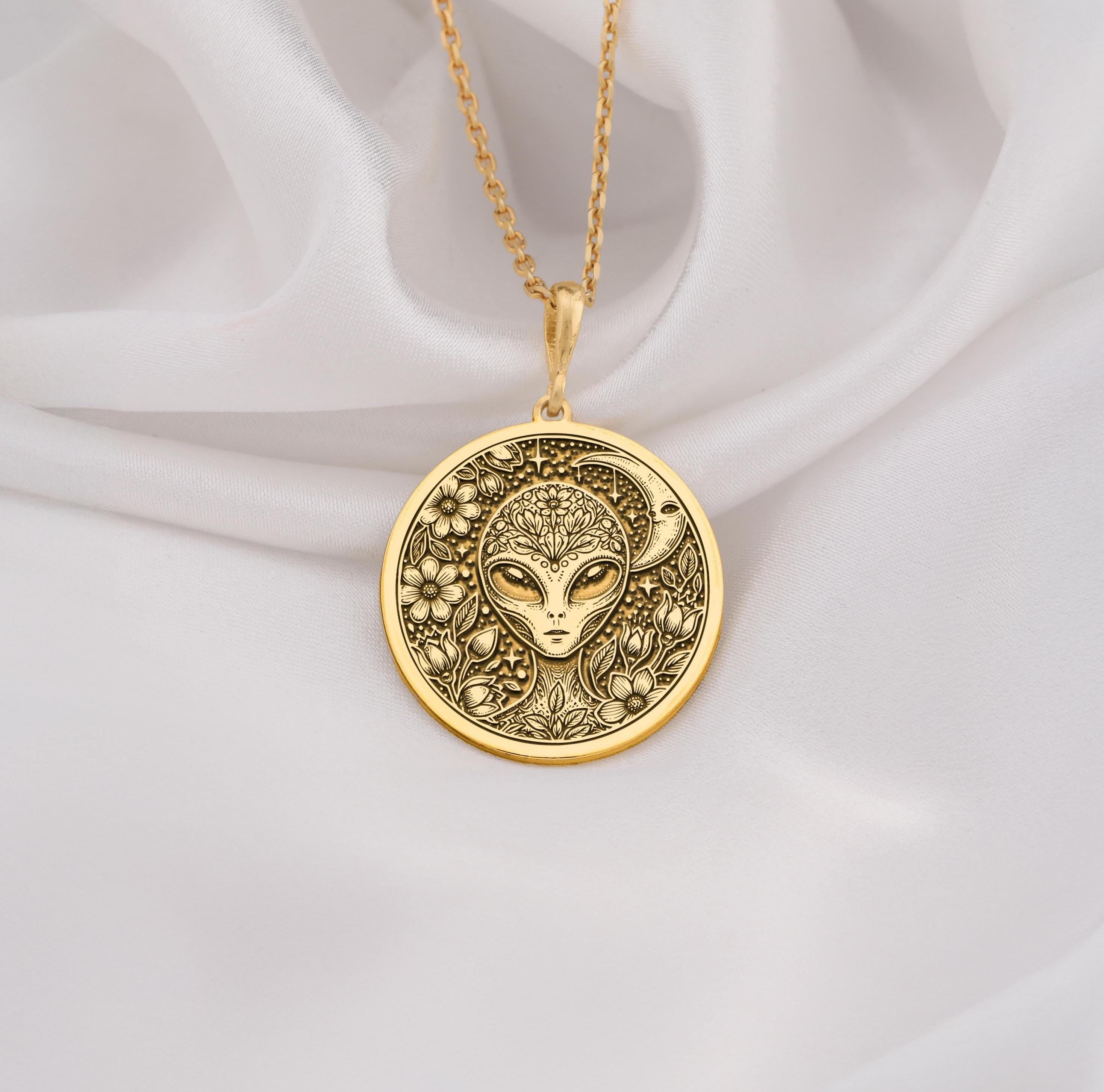 Mystical 14K gold alien pendant, featuring a detailed extraterrestrial medallion with floral cosmic engravings. A stunning sci-fi jewelry piece, perfect for space lovers, making it a unique gold cosmic charm.