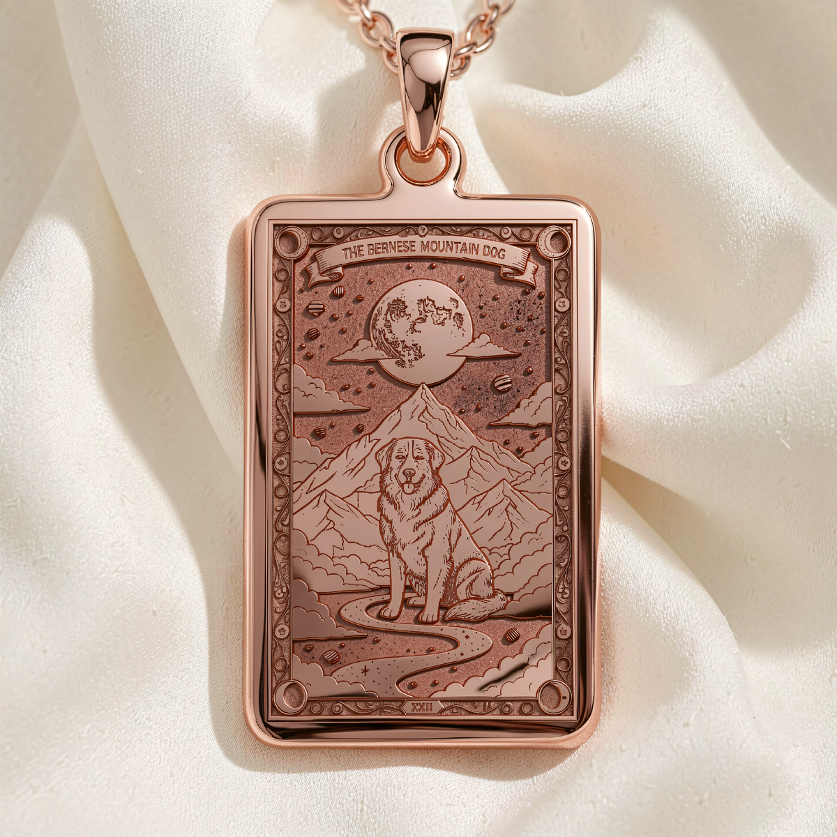 Bernese Mountain Dog Pendant in Rose Gold Plated finish shows front view of rectangular medallion with engraved dog, mountains and moon.