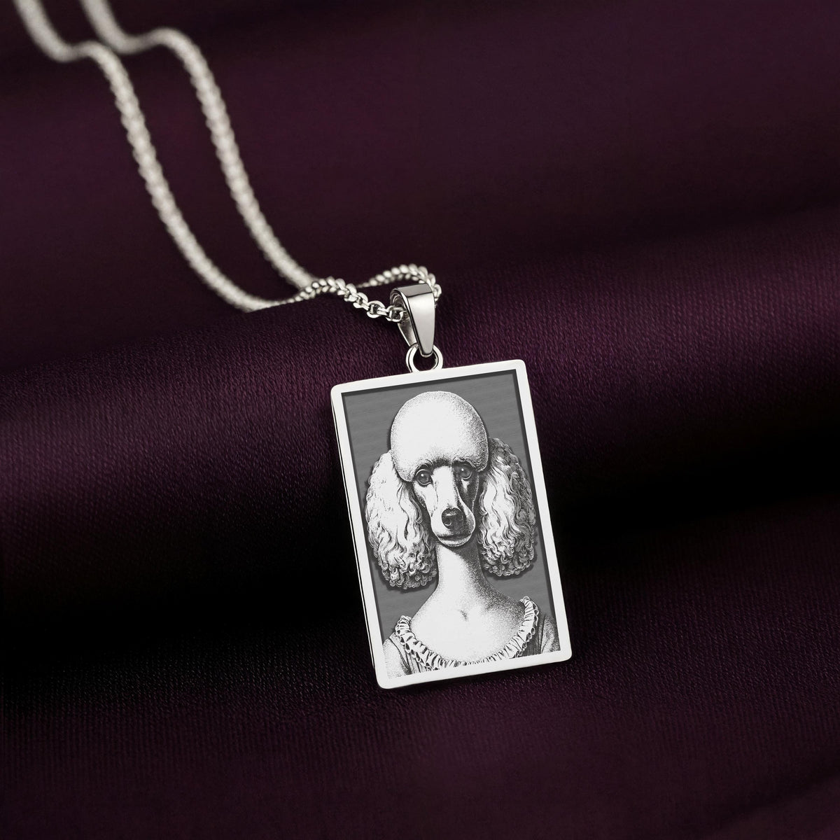 Sharp, detailed laser engraving of a Poodle on a minimalist 925 sterling silver tag necklace, a classic piece of pet jewelry.