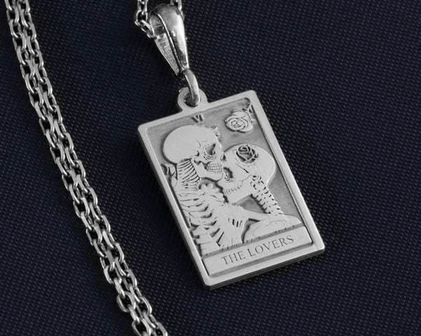 &quot;Silver &#39;The Lovers&#39; Skeleton Charm Necklace with two intertwined skeletons symbolizing eternal love. A unique gothic pendant, perfect for Halloween or romantic gifts. Silver-plated, adjustable chain. Ideal for dark, alternative fashion lovers.&quot;