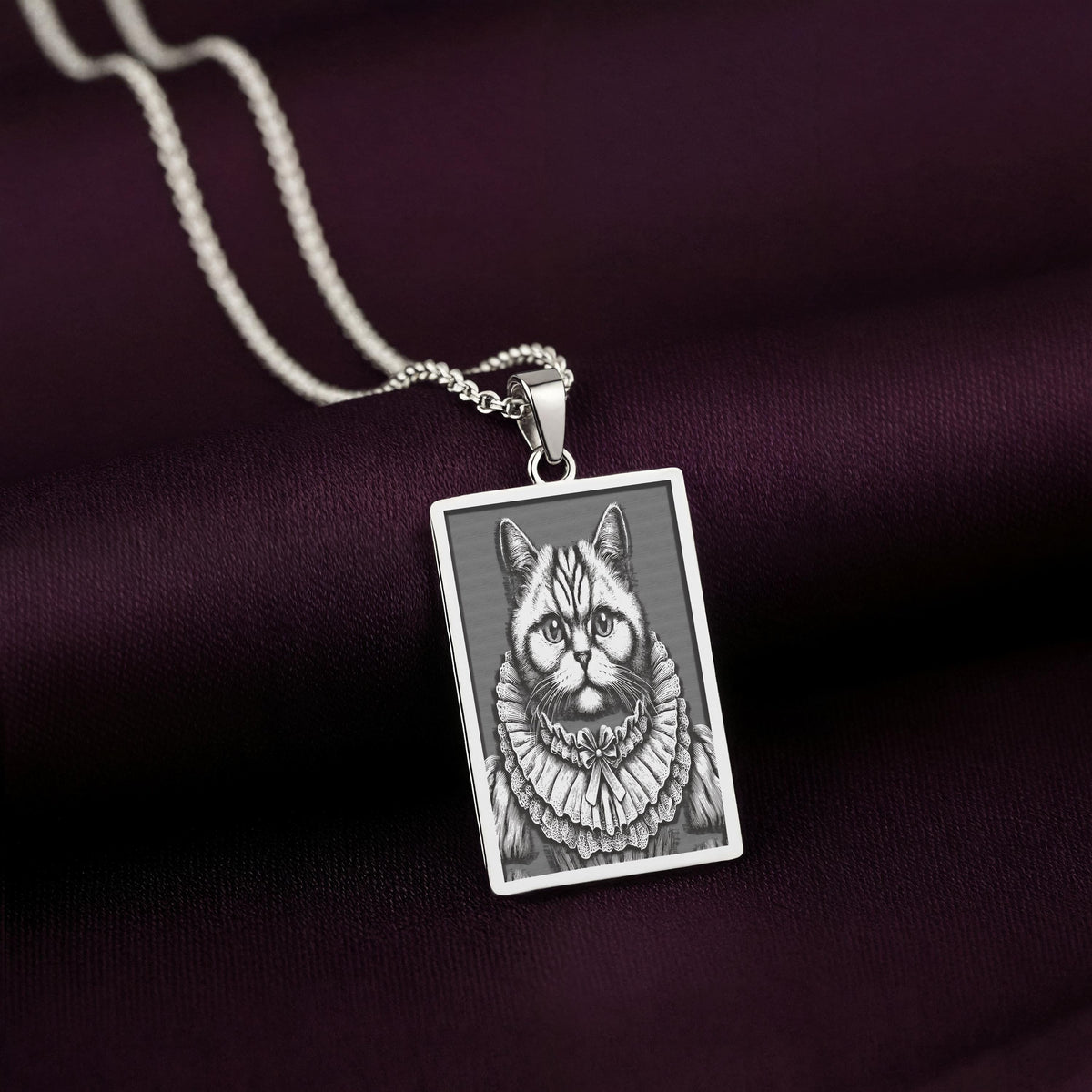 925 Sterling Silver version of The Ancestors Collection's British Shorthair necklace, with a cool tone contrasting against the rich purple fabric.