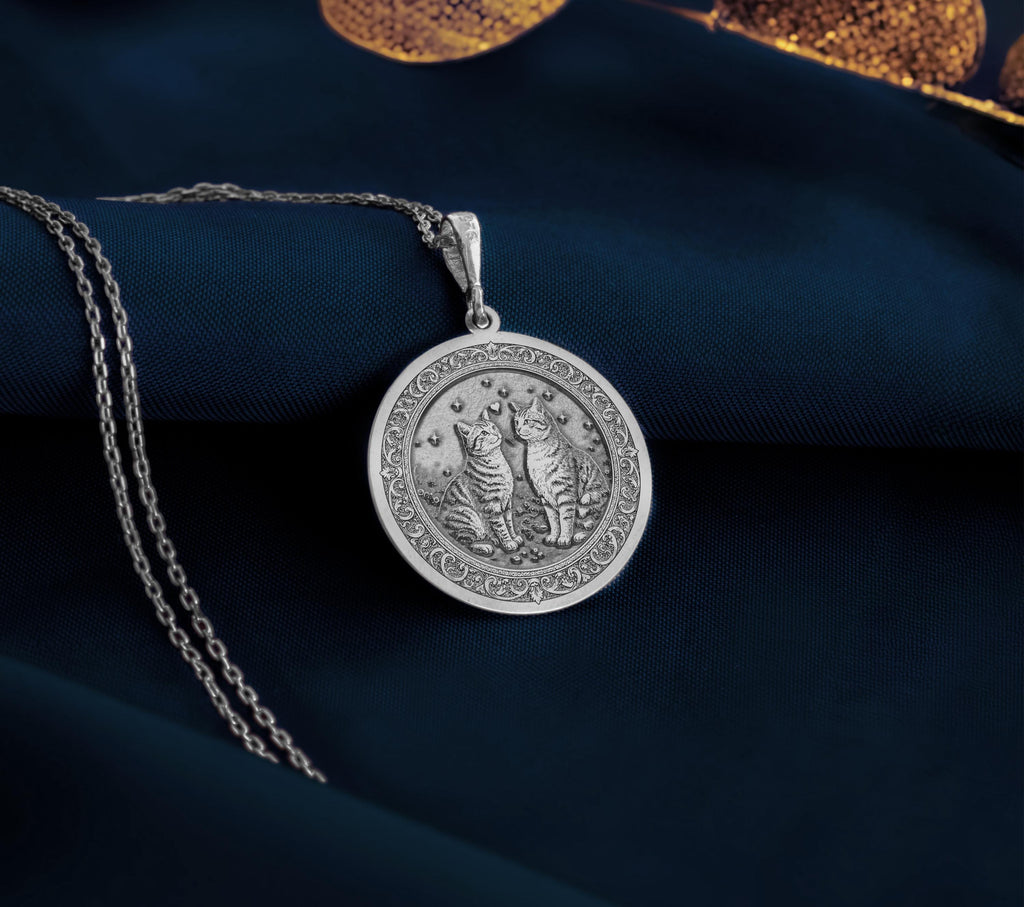 Sterling Silver Twin Cats Pendant with detailed celestial design. Handcrafted silver coin charm featuring beloved cat duo with starlit background and ornate elements. Memorial jewelry celebrating eternal bond with bonded cat companions.