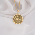 14K Solid Gold YES Medallion featuring powerful affirmation surrounded by wheat laurels and celestial motifs. Detailed empowerment talisman with sun, moon, bird and botanical symbols.Symbolizing positive decisions and abundant manifestation.