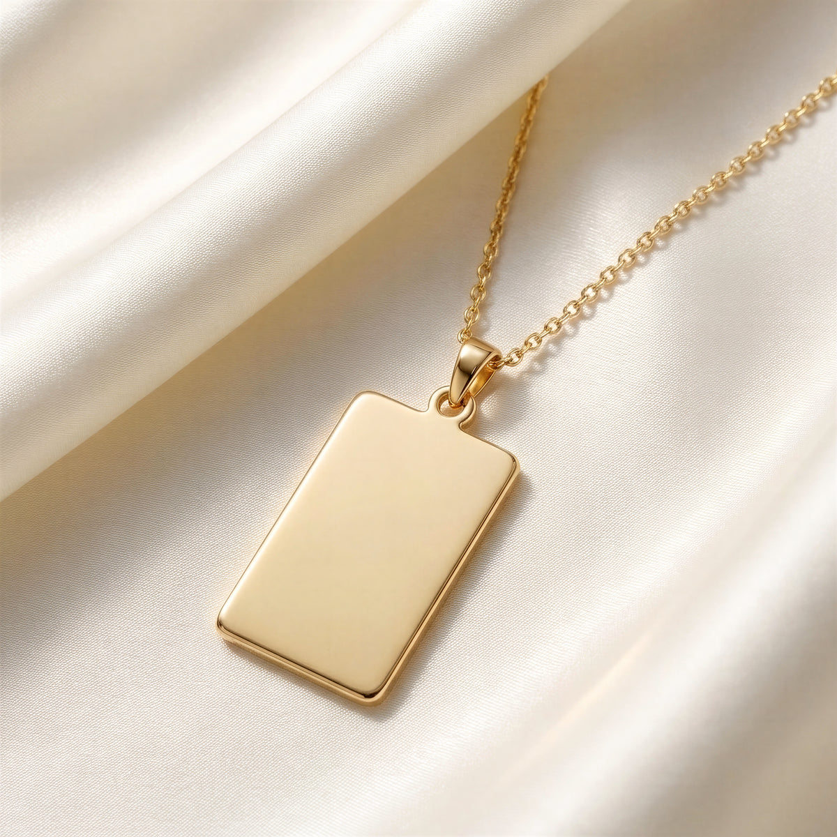 Custom Engravable Blank Rectangle Bar Pendant - 14K Gold Plated Editorial Close-Up on Ivory Mulberry Silk