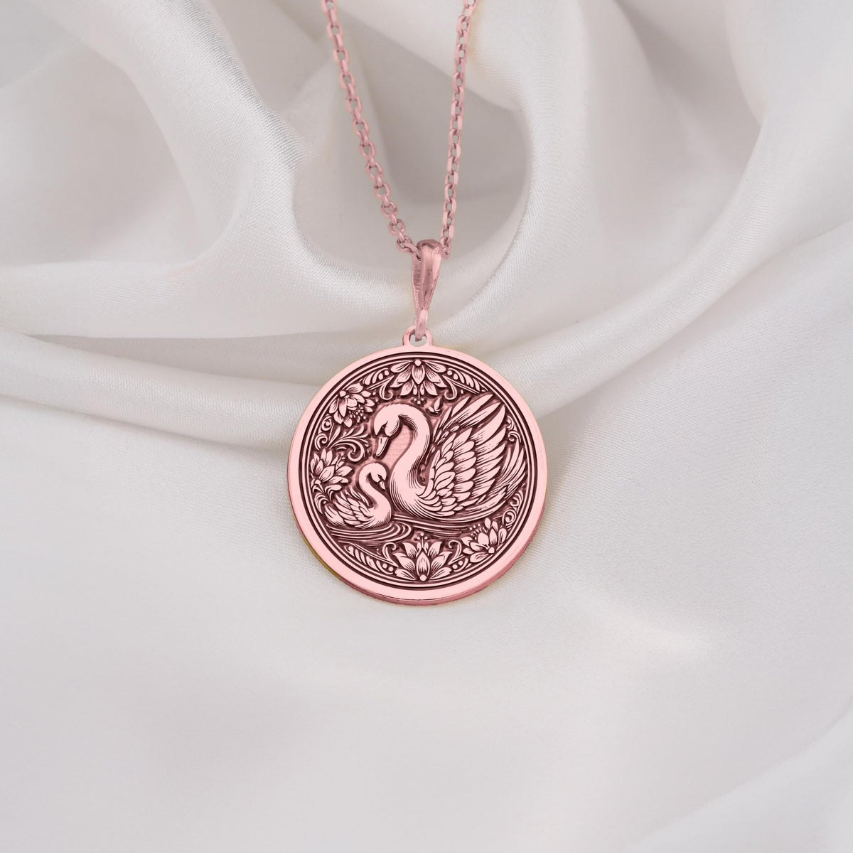 Rose Gold Plated Mother Baby Swan Medallion featuring protective mother swan with baby cygnet surrounded by ornate decorative elements. Elegant family jewelry with detailed maternal symbolism. Warm-toned love talisman.