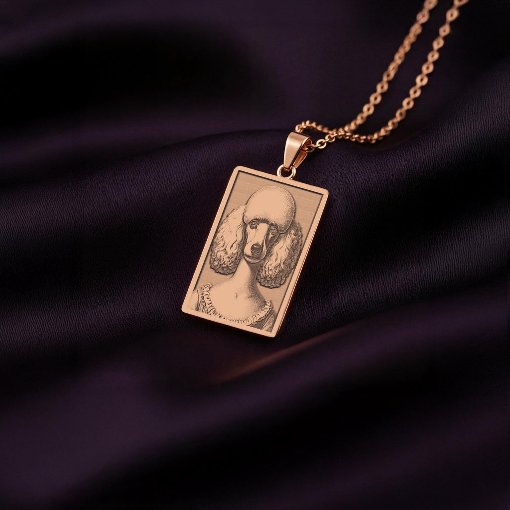A stylish rose gold plated necklace with a rectangular pendant, featuring a unique engraved portrait of a sophisticated Poodle dog.
