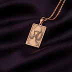 A stylish rose gold plated necklace with a rectangular pendant, featuring a unique engraved portrait of a sophisticated Poodle dog.