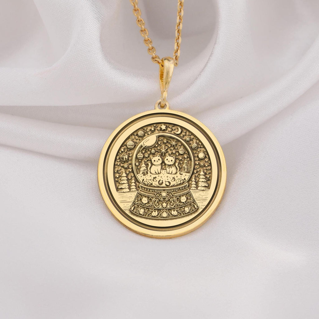 14K solid gold snow globe pendant featuring two cats inside a detailed coin-style medallion. Perfect gift for cat lovers and jewelry enthusiasts, handmade and adjustable for any outfit.