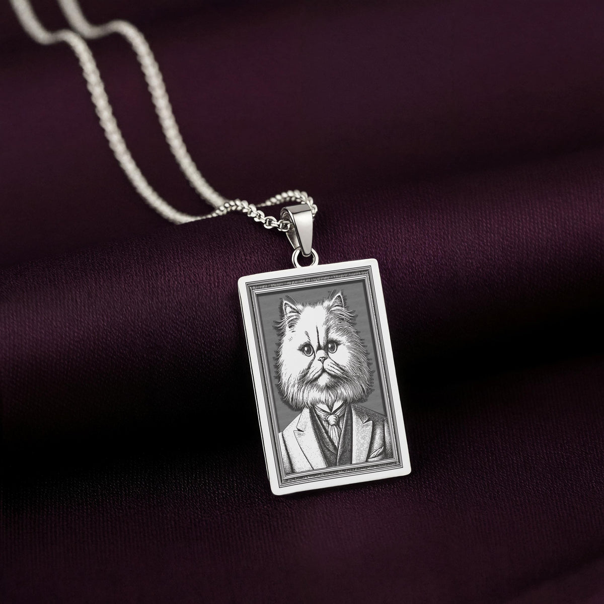 Another perspective of the 925 Sterling Silver Persian Cat necklace, with the lighting emphasizing the texture of the engraved waistcoat and the grumpy, yet regal, face.