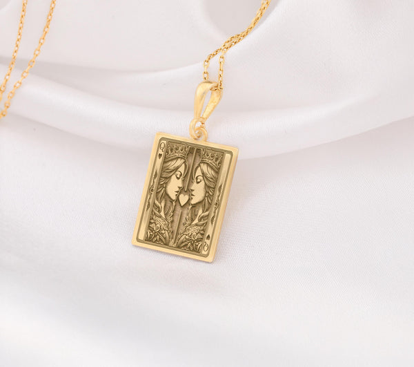 Gold Ace of Queens pendant featuring two queens facing each other with a heart symbol, representing love, unity, and empowerment. Perfect LGBTQ+ jewelry gift.