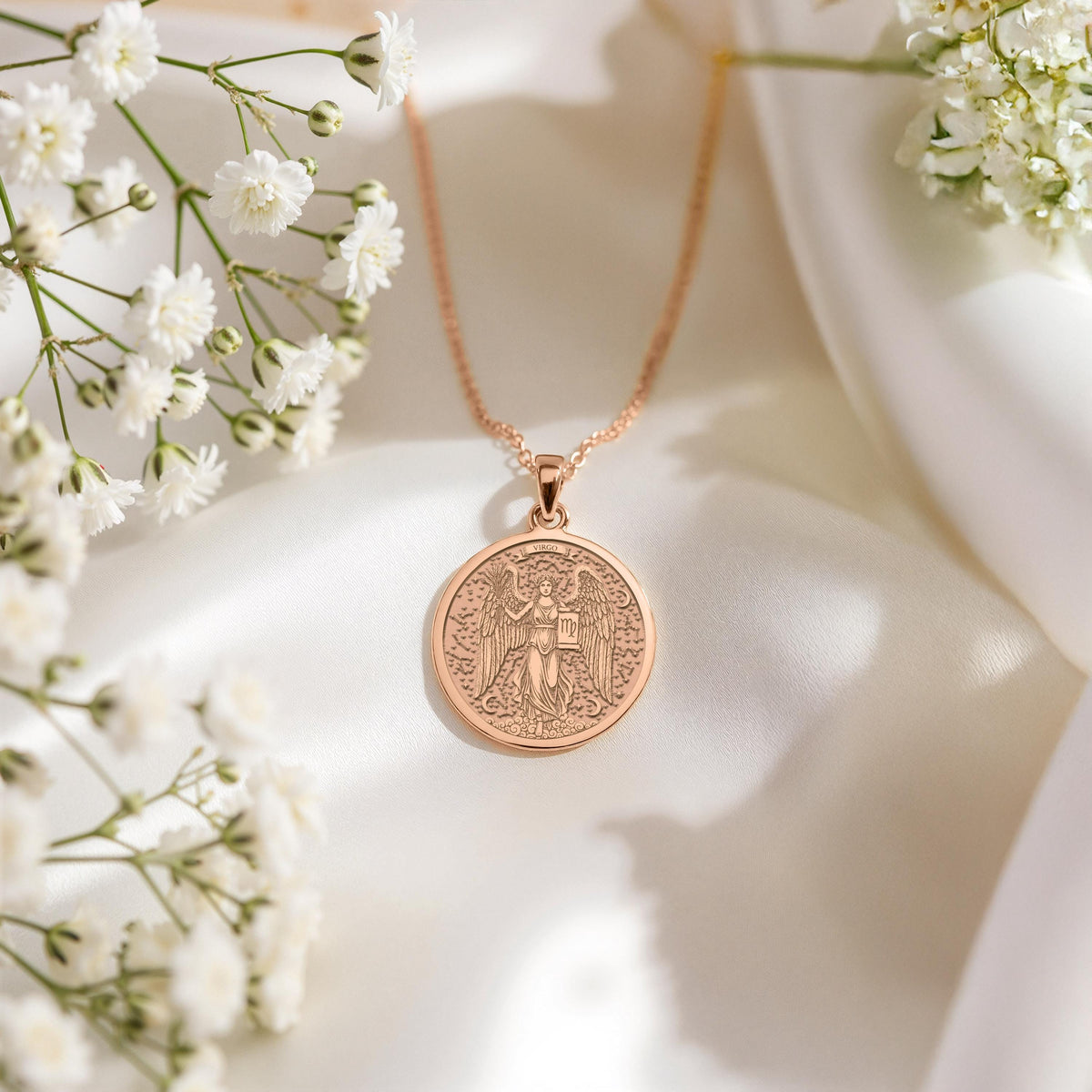 A unique rose gold plated round necklace with a custom engraved portrait of the Virgo zodiac angel. The detailed artwork is a perfect piece of spiritual jewelry for the Mercury-ruled sign.