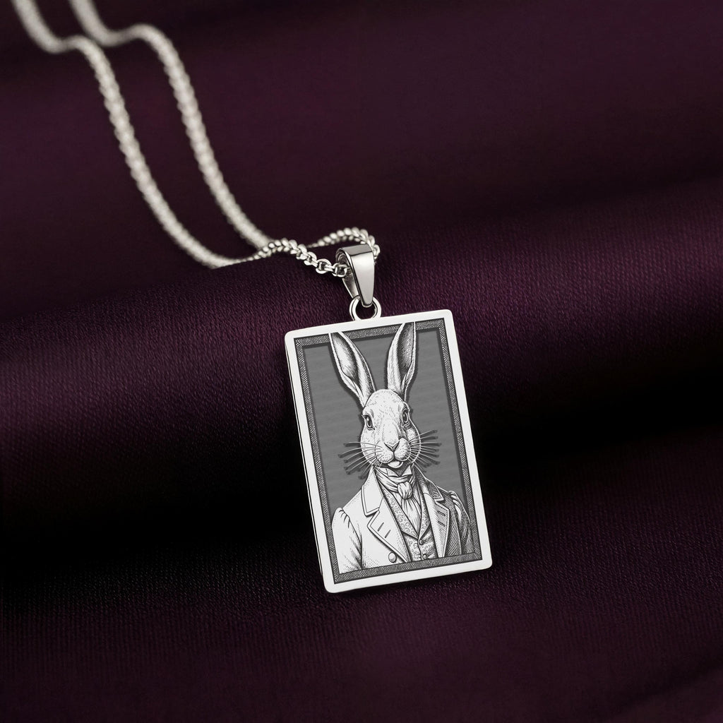 A handcrafted 925 sterling silver dapper rabbit charm in a rectangular shape. This personalized piece of anthropomorphic jewelry is a standout accessory for any gentleman.