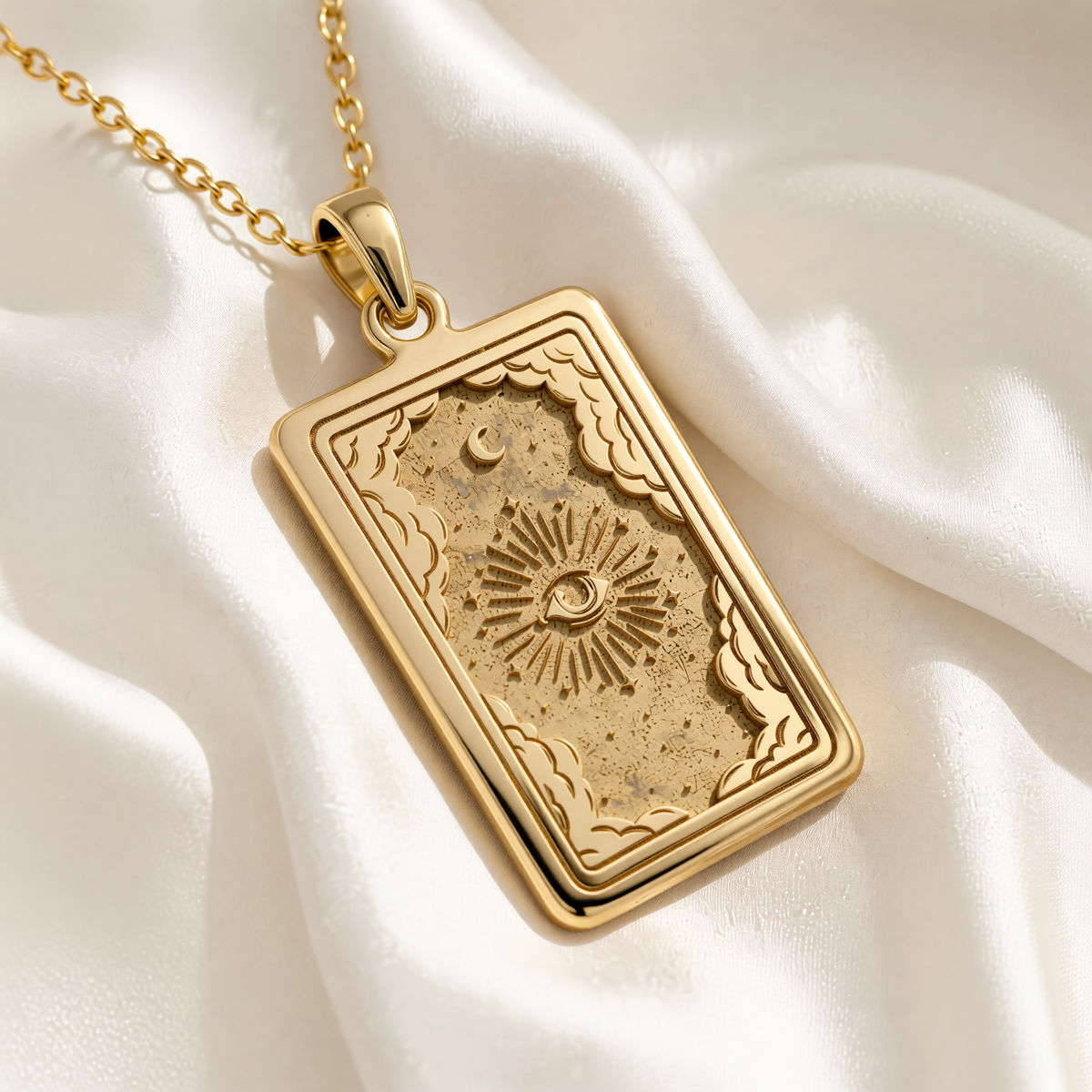Gold Plated Eye Tarot Necklace pendant features an engraved Eye of Providence with radiating lines, a crescent moon, and ornate cloud-like borders.