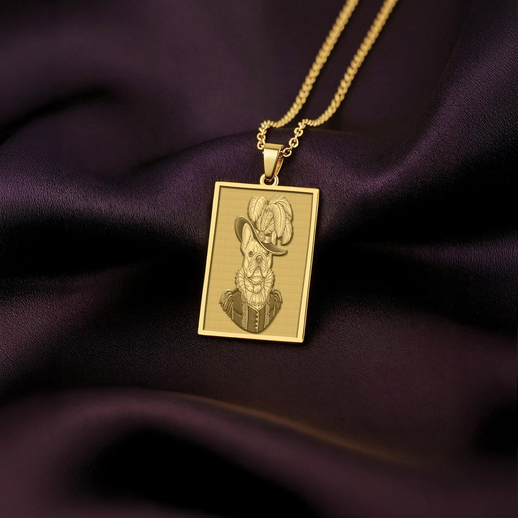 Product photo of a 14K Solid Gold French Bulldog necklace from 'The Ancestors Collection'. The rectangular pendant features an engraved dog in a plumed Renaissance hat, resting on rich purple satin.