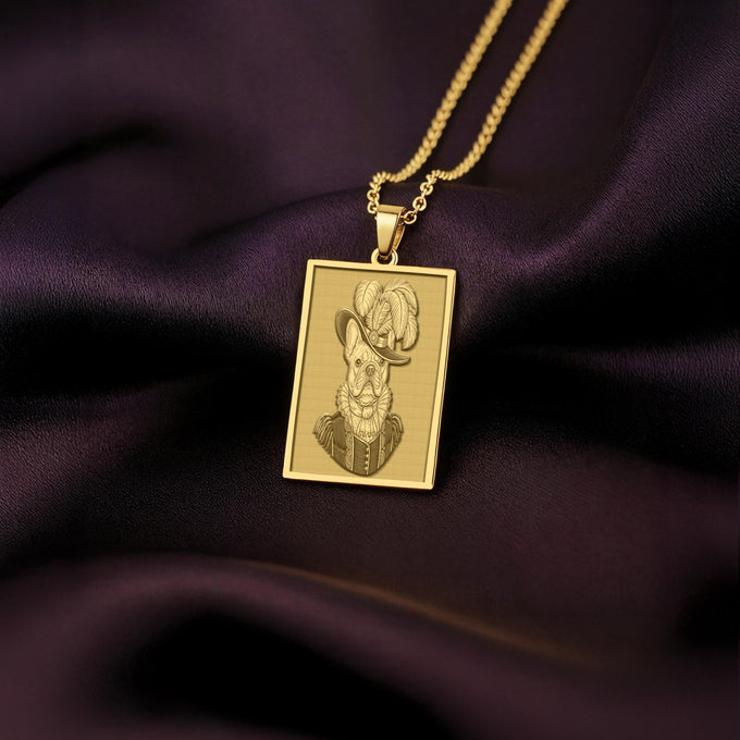 Product photo of a 14K Solid Gold French Bulldog necklace from 'The Ancestors Collection'. The rectangular pendant features an engraved dog in a plumed Renaissance hat, resting on rich purple satin.