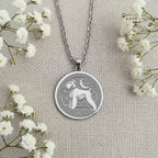 Sterling Silver Schnauzer coin necklace charm showing a finely detailed portrait of the beloved dog breed. Handcrafted pet memorial jewelry with an artistic, classic design. An ideal keepsake gift for any dog lover or Schnauzer mom