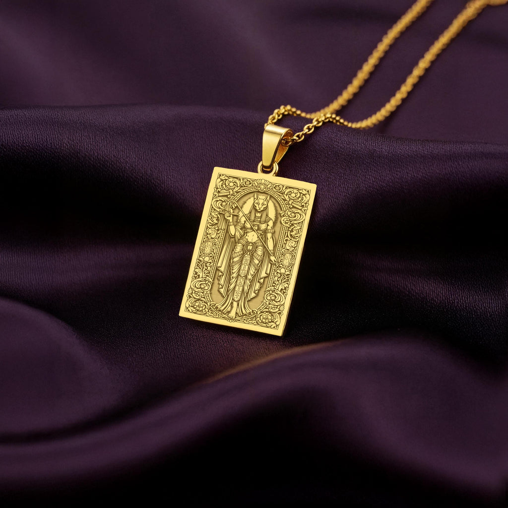 A rectangular 14K gold plated tarot card necklace featuring the Egyptian Cat Goddess, Bastet. This divine feline piece is a powerful protector of the home.
