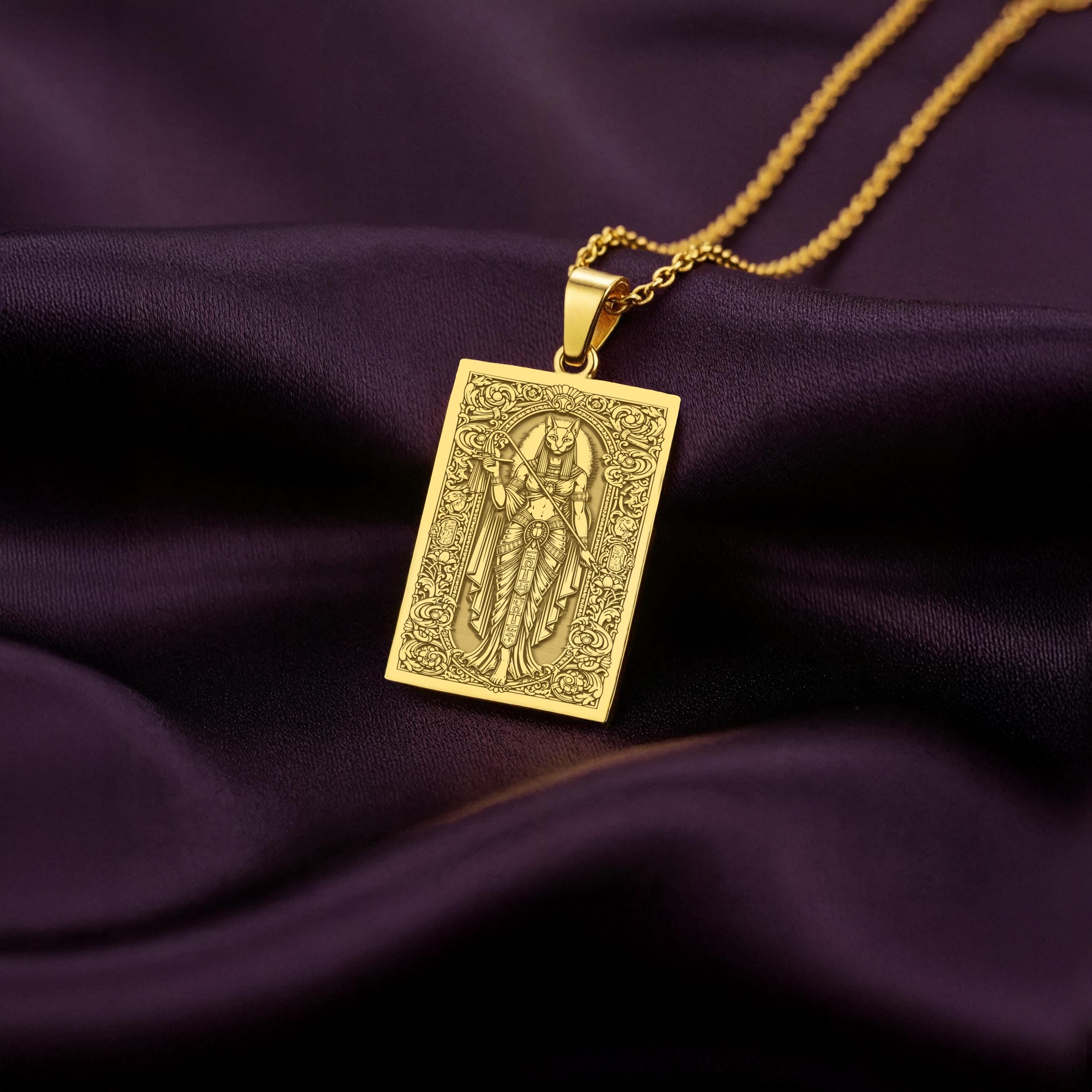 A rectangular 14K gold plated tarot card necklace featuring the Egyptian Cat Goddess, Bastet. This divine feline piece is a powerful protector of the home.