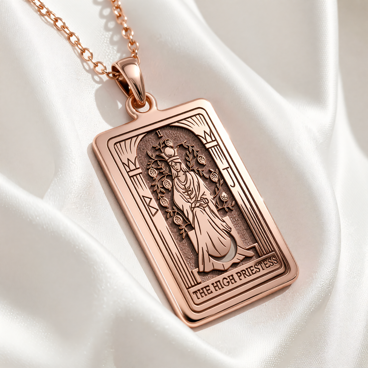 Rose gold plated High Priestess Tarot pendant showing seated figure between columns with THE HIGH PRIESTESS inscription.