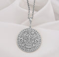 Silver pendant with an Aztec Sun Stone Calendar Medallion design. The circular pendant features intricate geometric patterns and depictions of ancient symbols in a detailed relief style. It is shown from the front, hanging from a silver chain.