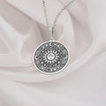 Sun Celestial Necklace: Sterling silver pendant with engraved sun face, stars and moon motifs.