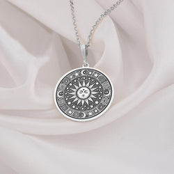 Sun Celestial Necklace: Sterling silver pendant with engraved sun face, stars and moon motifs.
