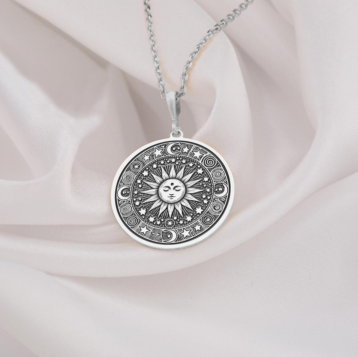 Sun Celestial Necklace: Sterling silver pendant with engraved sun face, stars and moon motifs.