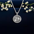Dorian Gray Portrait Pendant: sterling silver round pendant with engraved portrait and reflection in ornate mirror, front view.