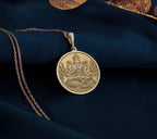 Ganga Goddess Pendant Necklace Necklaces 14K 14K Gold Plated plated round pendant with seated spiritual figure design on a gold chain.