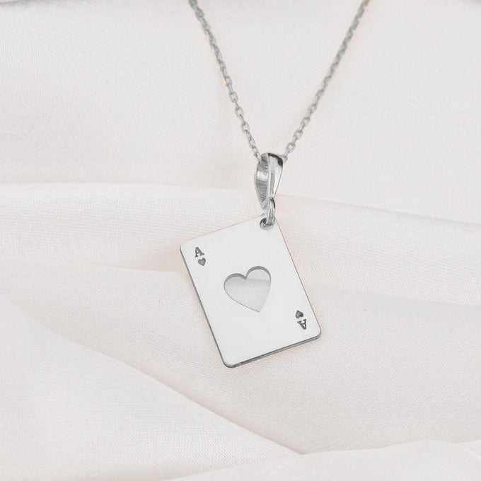 Silver pendant shaped like an Ace of Hearts playing card, featuring a heart cut-out in the middle and an 'A' in the top left and bottom right corners.