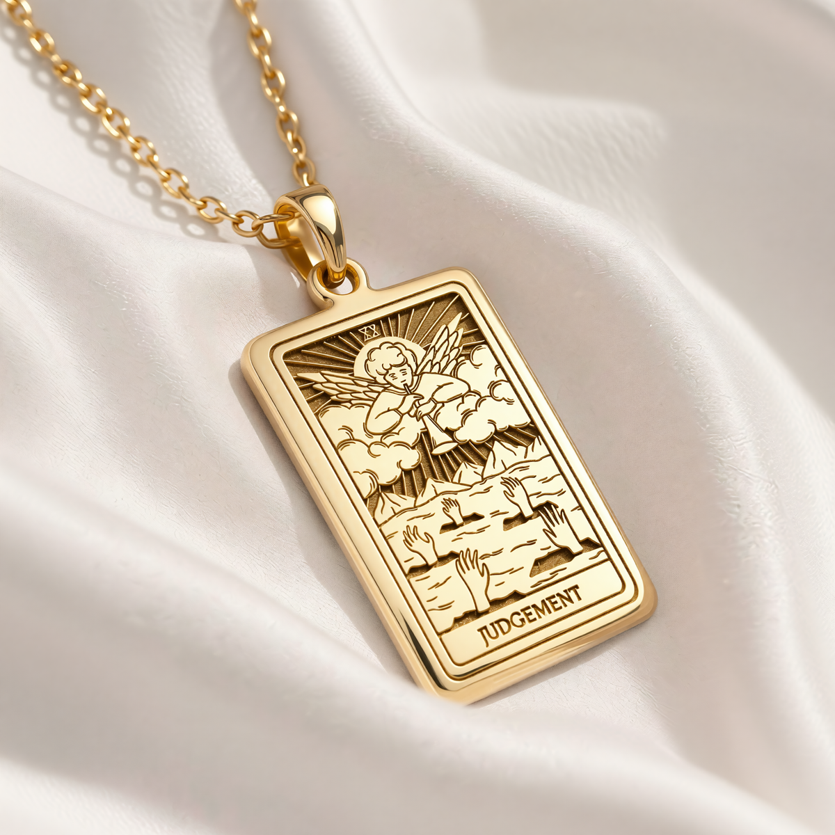 Gold-plated Judgement Tarot necklace: rectangular pendant with angel blowing a trumpet and rising hands.