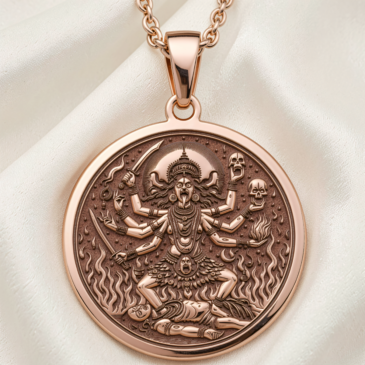 Kali Ma Goddess Skull Garland Pendant in 14K Rose Gold Plated. Front view of round pendant showing multi-armed deity with skulls, swords and flames.