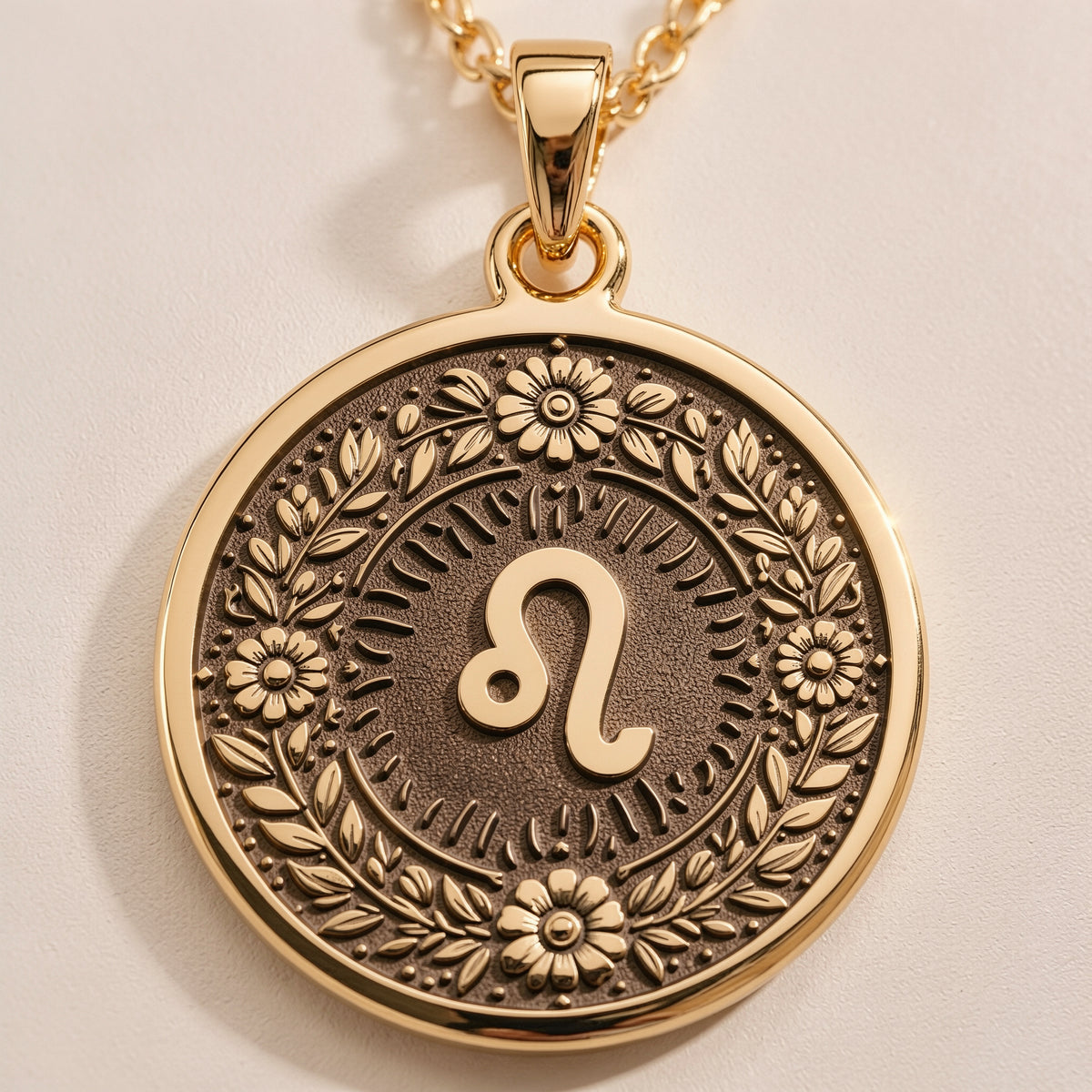 Leo Zodiac Astrological Sign Medallion Necklaces 14K 14K Gold Plated pendant necklace featuring an ornate circular design with floral engravings and a stylized infinity loop.
